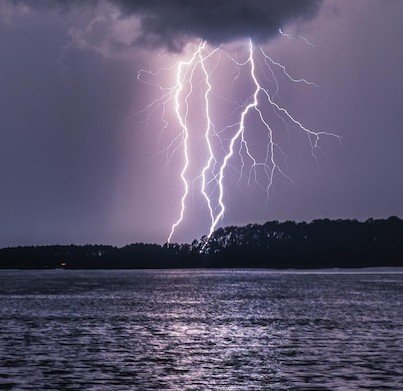 beautiful-shot-triple-close-lightning-strikes-with-reflection-lake_665346-61039.jpg